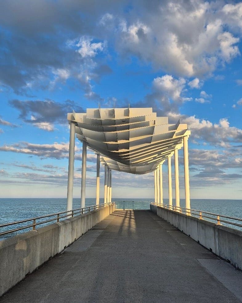 The Napier Marine Parade viewing platform at golden hour, looking out over the Hawke's Bay coastline