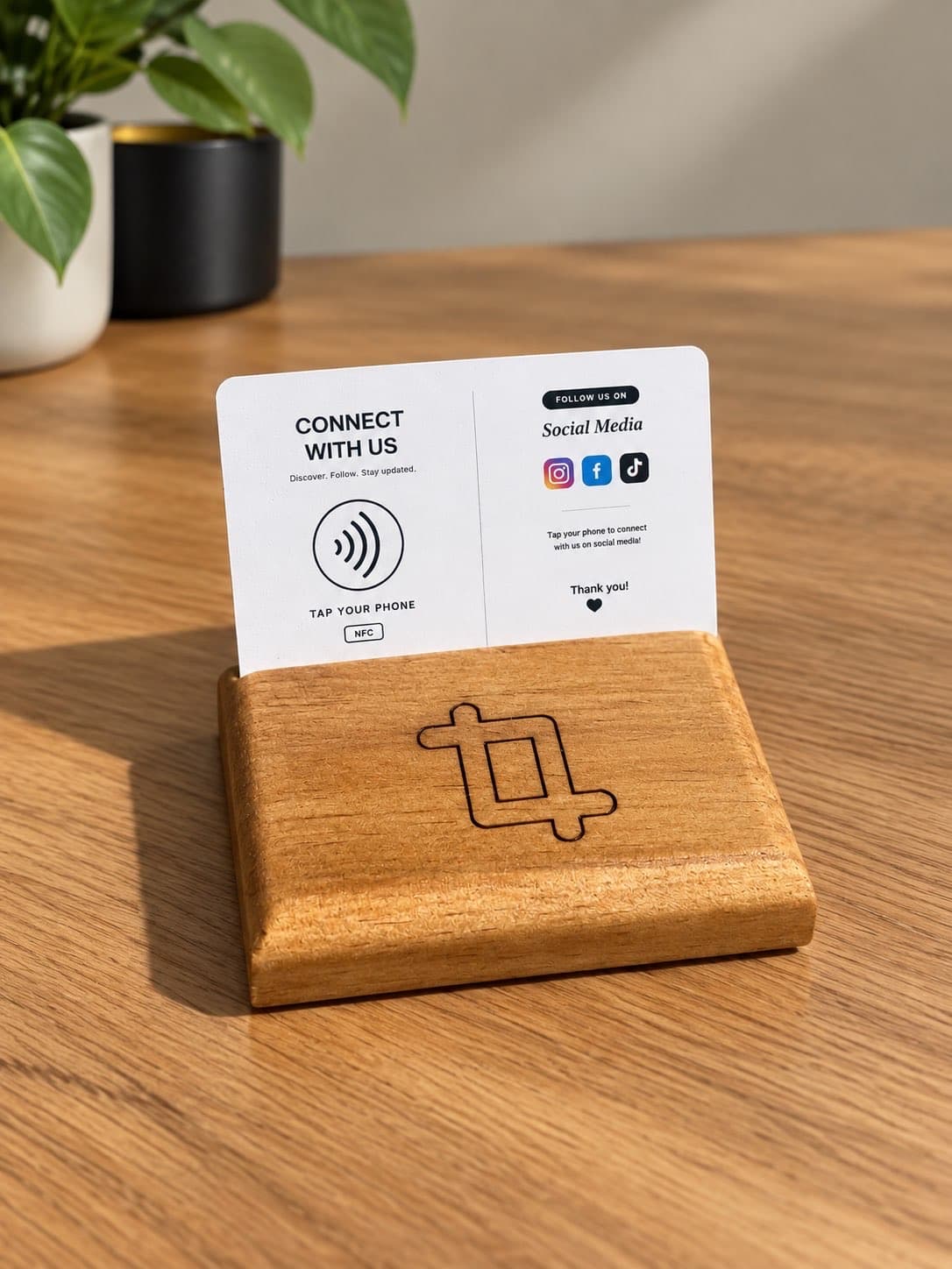 Local Link Connect With Us NFC card in a wooden stand engraved with the Local Link logo